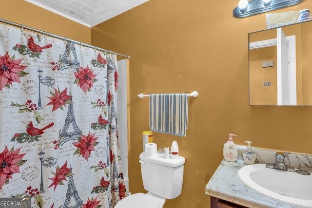 bathroom featuring vanity, a textured ceiling, ornamental molding, and toilet