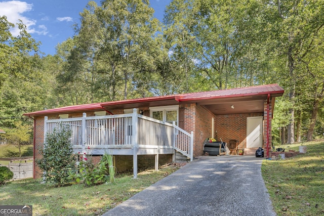 view of front of house with a carport and a front lawn