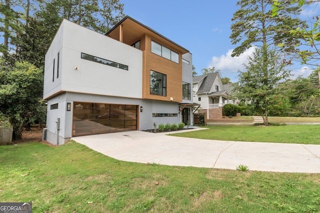 modern home with a garage and a front lawn