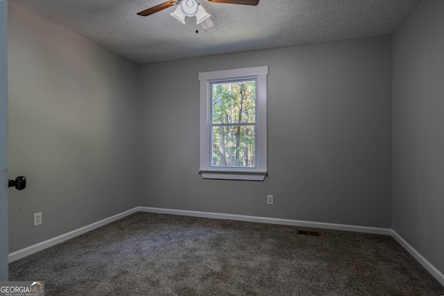 carpeted spare room with a textured ceiling and ceiling fan