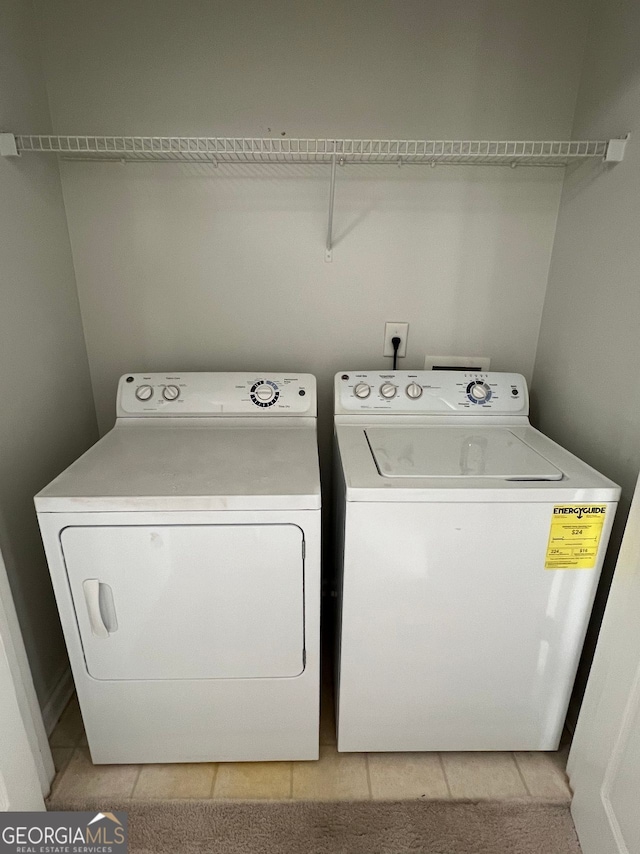 laundry area featuring light tile patterned flooring and separate washer and dryer