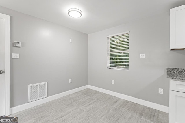 unfurnished dining area featuring visible vents and baseboards