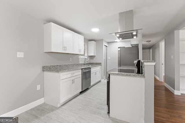 kitchen featuring white cabinets, island range hood, light stone counters, and appliances with stainless steel finishes