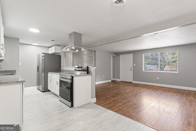 kitchen featuring appliances with stainless steel finishes, white cabinetry, visible vents, and island range hood