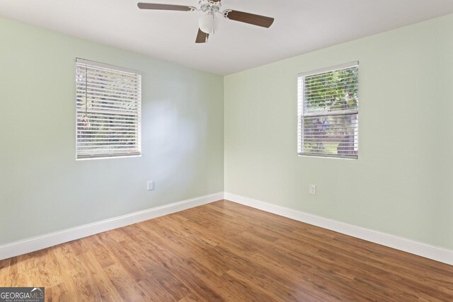 unfurnished room featuring hardwood / wood-style floors and ceiling fan