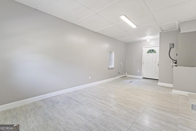 empty room featuring a paneled ceiling