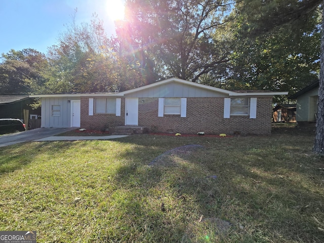 single story home featuring crawl space, brick siding, board and batten siding, and a front yard