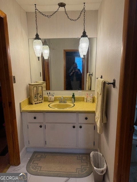 bathroom with tile patterned flooring, vanity, and toilet