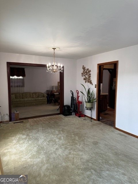 carpeted dining area with a chandelier