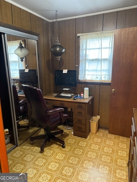 office area featuring ornamental molding and wooden walls