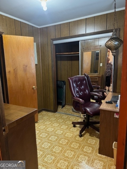 office area with wooden walls and crown molding