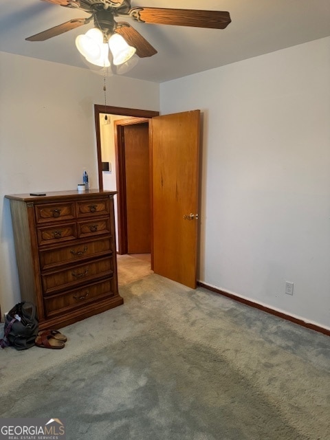 unfurnished bedroom featuring ceiling fan and light colored carpet