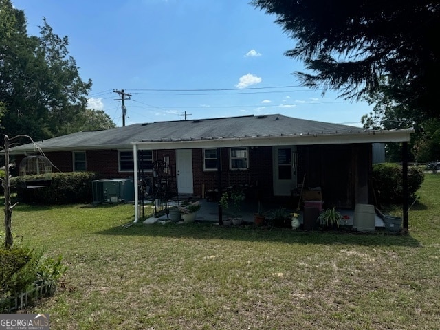 rear view of house with a lawn