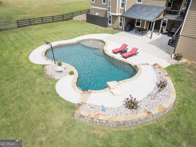 view of pool featuring a yard and a patio area