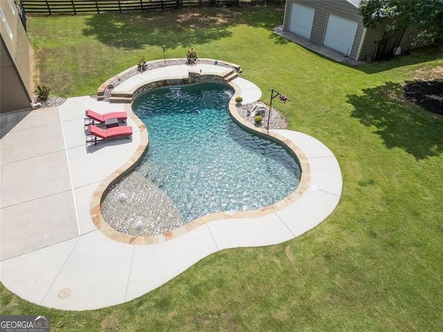 view of pool with a patio area and a yard