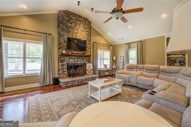 living room with ornamental molding, light wood-type flooring, vaulted ceiling, and ceiling fan