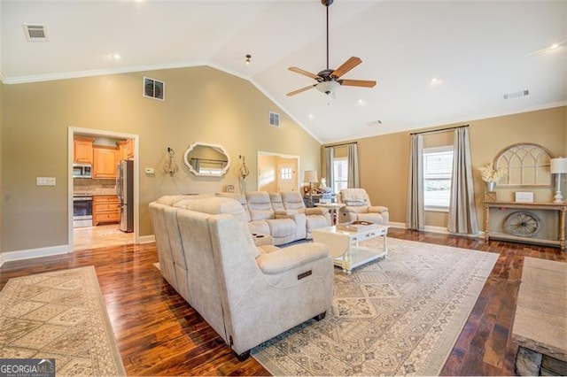 living room with ceiling fan, crown molding, dark wood-type flooring, and high vaulted ceiling