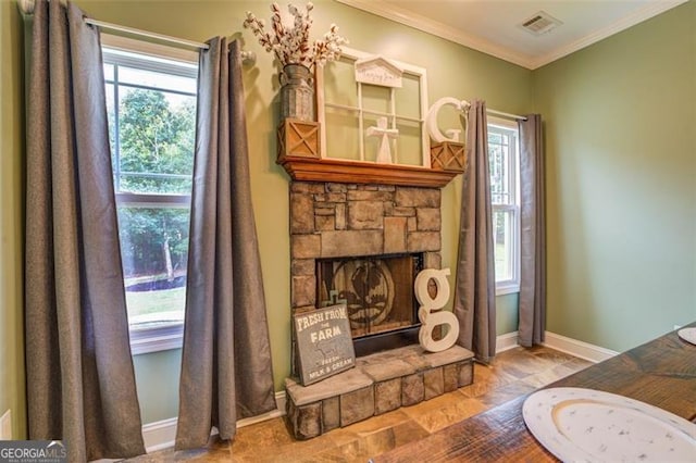 interior space with a stone fireplace and ornamental molding