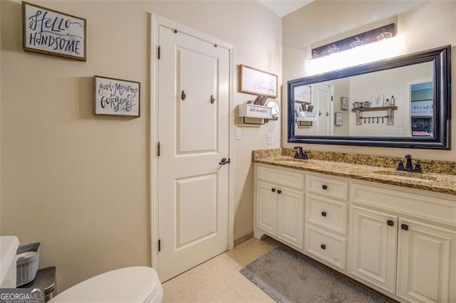 bathroom with vanity, toilet, and tile patterned floors