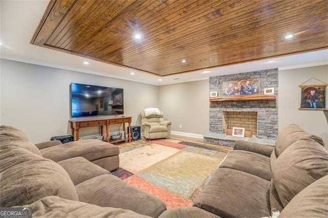 living room featuring wood ceiling, hardwood / wood-style floors, and a stone fireplace