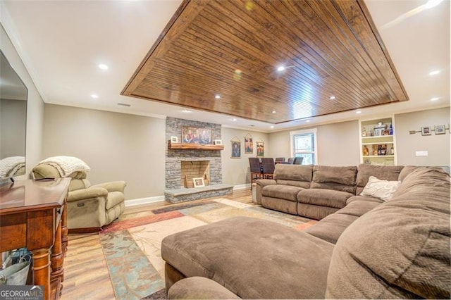 living room with wood ceiling, light wood-type flooring, and a fireplace