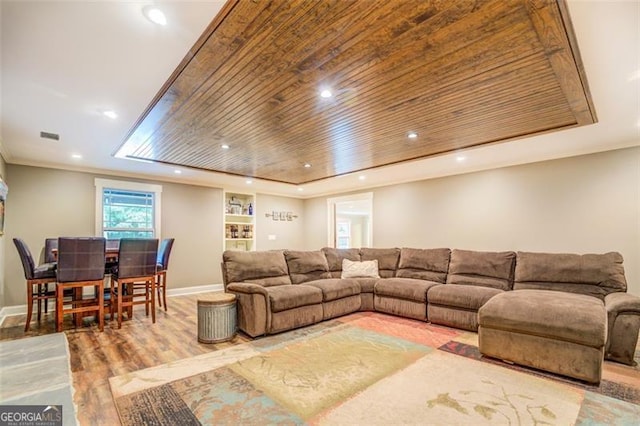 living room featuring light hardwood / wood-style flooring and wood ceiling