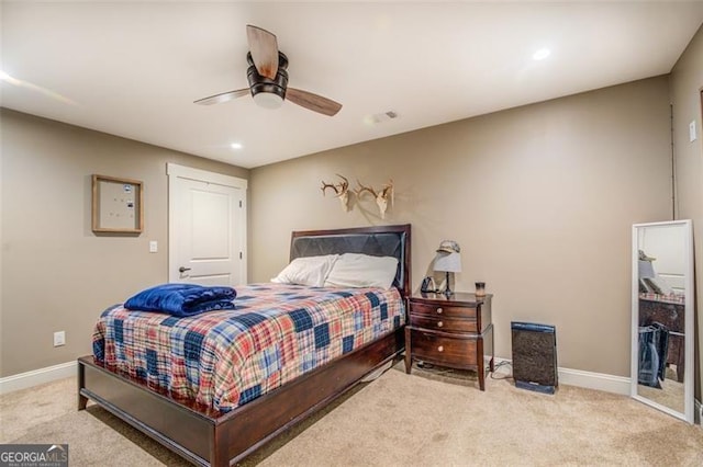 bedroom featuring ceiling fan, a closet, and light carpet