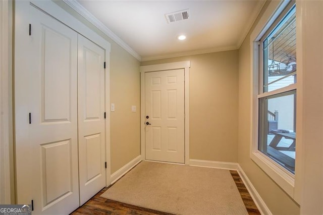 doorway to outside featuring dark hardwood / wood-style floors and crown molding