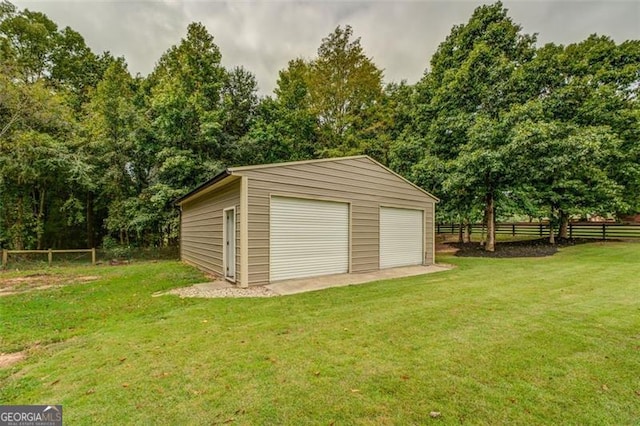 garage featuring a lawn