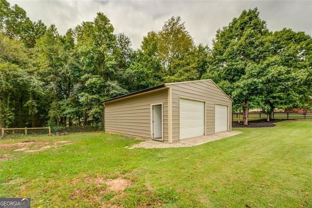 view of outbuilding with a garage and a yard