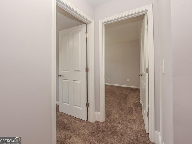 corridor featuring carpet flooring and baseboards