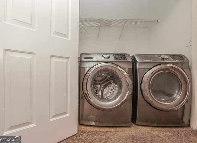 washroom featuring carpet, laundry area, and separate washer and dryer