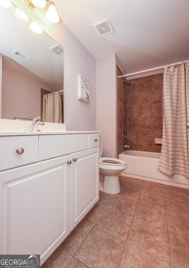 bathroom with toilet, vanity, visible vents, and tile patterned floors