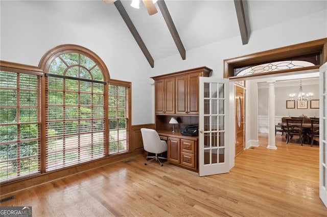 office with ceiling fan with notable chandelier, built in desk, light hardwood / wood-style floors, and high vaulted ceiling