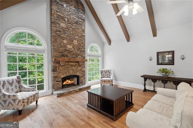 living room with light hardwood / wood-style flooring, ceiling fan, and high vaulted ceiling