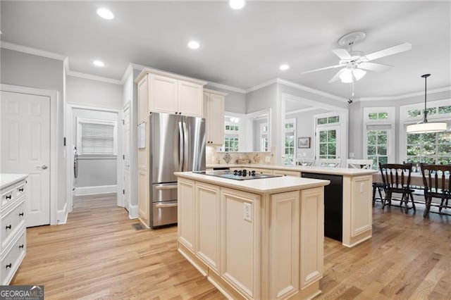 kitchen with light hardwood / wood-style floors, ceiling fan, a kitchen island, and stainless steel fridge