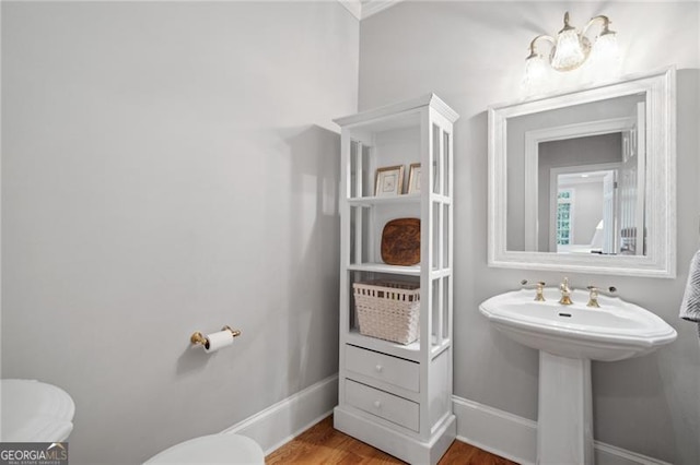 bathroom with wood-type flooring and toilet