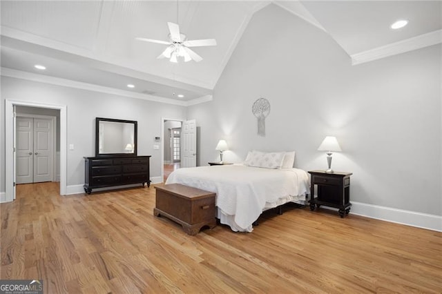 bedroom with light wood-type flooring, crown molding, lofted ceiling, and ceiling fan