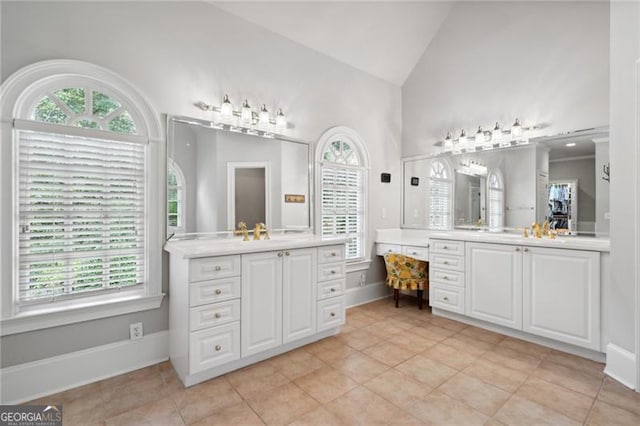 bathroom featuring vanity, vaulted ceiling, and tile patterned floors