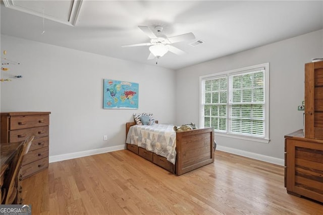 bedroom with ceiling fan and light hardwood / wood-style flooring