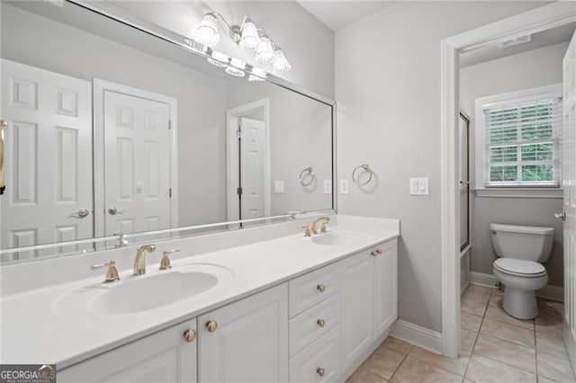 full bathroom with tile patterned flooring, shower / bath combination with glass door, vanity, and toilet