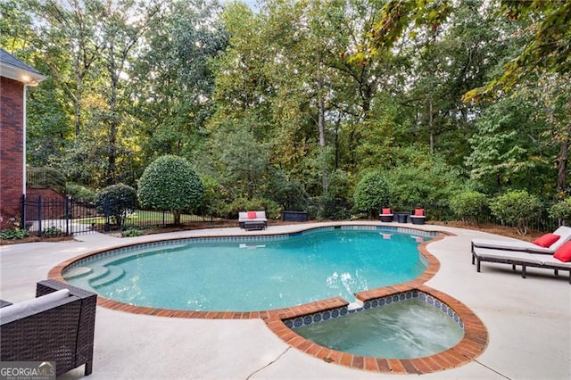 view of pool featuring an in ground hot tub and a patio area