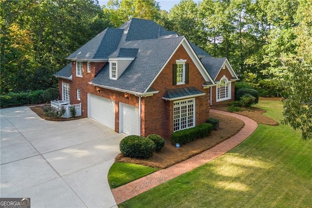 view of property with a front lawn and a garage