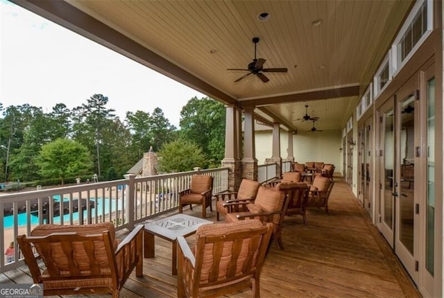 wooden terrace featuring ceiling fan