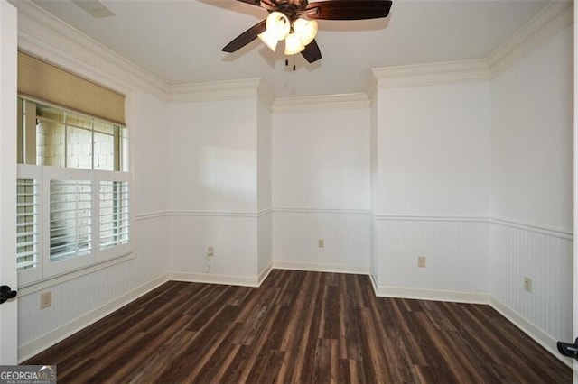 spare room featuring ceiling fan, dark hardwood / wood-style floors, and ornamental molding