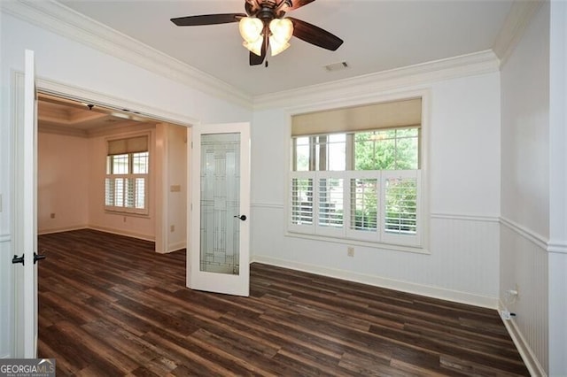 spare room featuring plenty of natural light, dark wood-type flooring, french doors, and ornamental molding