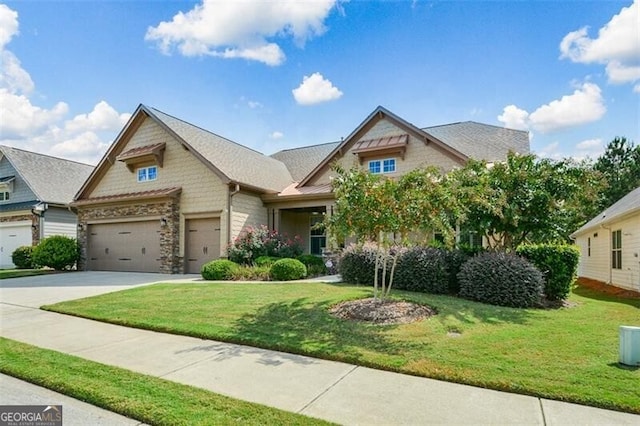 view of front of property with a garage and a front lawn