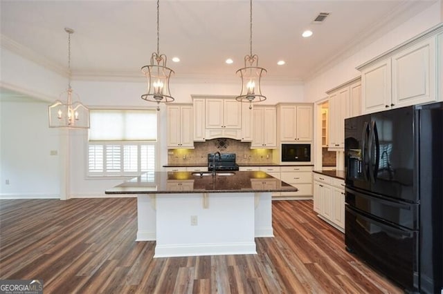 kitchen with pendant lighting, dark hardwood / wood-style flooring, a kitchen island with sink, and black appliances