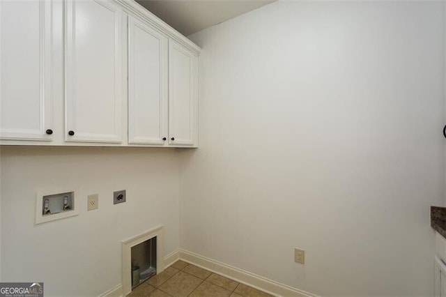 laundry area featuring hookup for an electric dryer, light tile patterned flooring, cabinets, and washer hookup