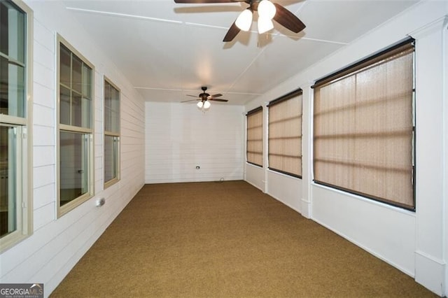 unfurnished sunroom with ceiling fan